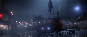 Movie still from “1941” (1979), directed by Steven Spielberg – A double - decker bus driving down a street at night; Extreme Wide shot, Low angle