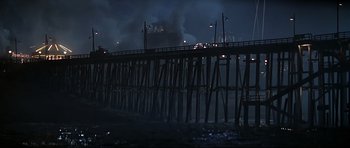 Movie still from “1941” (1979), directed by Steven Spielberg – A pier with a ship in the background at night; Extreme Wide shot, Low angle