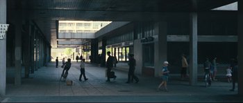Movie still from “2 or 3 Things I Know About Her” (1967), directed by Jean-Luc Godard – A group of people walking down a sidewalk; Extreme Wide shot, High angle