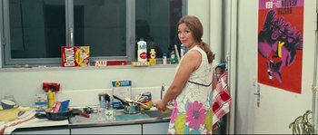Movie still from “2 or 3 Things I Know About Her” (1967), directed by Jean-Luc Godard – A woman in a kitchen preparing food in a pot; Medium shot, High angle