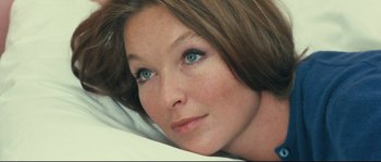 Movie still from “2 or 3 Things I Know About Her” (1967), directed by Jean-Luc Godard – A person with blue eyes laying down; Close Up shot, High angle