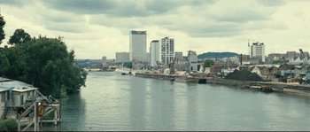 Movie still from “2 or 3 Things I Know About Her” (1967), directed by Jean-Luc Godard – A large body of water near a large city; Extreme Wide shot, High angle