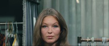Movie still from “2 or 3 Things I Know About Her” (1967), directed by Jean-Luc Godard – A person with long brown hair; Close Up shot, Over the shoulder angle