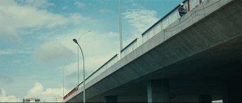 Movie still from “2 or 3 Things I Know About Her” (1967), directed by Jean-Luc Godard – A view of a street light from underneath a bridge; Extreme Wide shot, Low angle