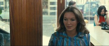 Movie still from “2 or 3 Things I Know About Her” (1967), directed by Jean-Luc Godard – A person standing near a door; Close Up shot, Over the shoulder angle