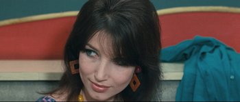 Movie still from “2 or 3 Things I Know About Her” (1967), directed by Jean-Luc Godard – A person wearing earrings; Close Up shot, High angle