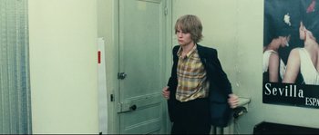 Movie still from “2 or 3 Things I Know About Her” (1967), directed by Jean-Luc Godard – A young man is walking through a door way; Medium shot, Over the shoulder angle