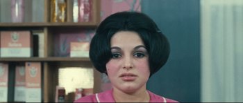 Movie still from “2 or 3 Things I Know About Her” (1967), directed by Jean-Luc Godard – A person wearing a pink shirt; Close Up shot, High angle