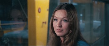 Movie still from “2 or 3 Things I Know About Her” (1967), directed by Jean-Luc Godard – A person with long brown hair; Close Up shot, Over the shoulder angle