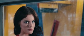 Movie still from “2 or 3 Things I Know About Her” (1967), directed by Jean-Luc Godard – A beautiful woman with blue eyes looking at the camera; Close Up shot, Low angle