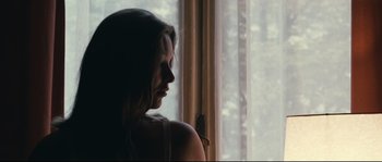 Movie still from “2 or 3 Things I Know About Her” (1967), directed by Jean-Luc Godard – A woman sitting in front of a window looking out the window; Close Up shot, Low angle