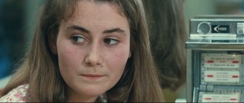 Movie still from “2 or 3 Things I Know About Her” (1967), directed by Jean-Luc Godard – A young woman's face; Close Up shot, Over the shoulder angle