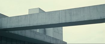 Movie still from “2 or 3 Things I Know About Her” (1967), directed by Jean-Luc Godard – A concrete structure with a sky in the background; Extreme Wide shot, Low angle
