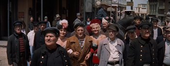 Movie still from “20,000 Leagues Under the Sea” (1954), directed by Richard Fleischer – A group of men and women wearing hats and costumes; Medium shot, Low angle
