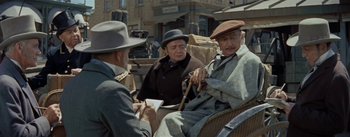 Movie still from “20,000 Leagues Under the Sea” (1954), directed by Richard Fleischer – A group of men sitting on top of a horse drawn carriage; Medium shot, Over the shoulder angle