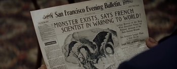 Movie still from “20,000 Leagues Under the Sea” (1954), directed by Richard Fleischer – An old newspaper with an image of a dragon on it; Extreme Close Up shot, High angle