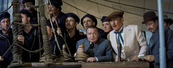 Movie still from “20,000 Leagues Under the Sea” (1954), directed by Richard Fleischer – A group of men standing next to each other holding ropes; Medium shot, High angle