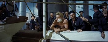 Movie still from “20,000 Leagues Under the Sea” (1954), directed by Richard Fleischer – A man with a shaving brush in his mouth; Medium shot, High angle