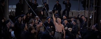 Movie still from “20,000 Leagues Under the Sea” (1954), directed by Richard Fleischer – A group of people sitting in a room; Wide shot, High angle