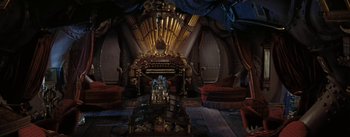 Movie still from “20,000 Leagues Under the Sea” (1954), directed by Richard Fleischer – An organ in a room that has a lot of furniture in it; Extreme Wide shot, Overhead angle
