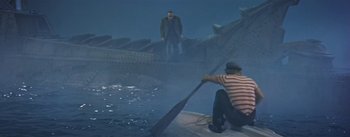 Movie still from “20,000 Leagues Under the Sea” (1954), directed by Richard Fleischer – A man standing on top of a boat next to another man; Wide shot, High angle
