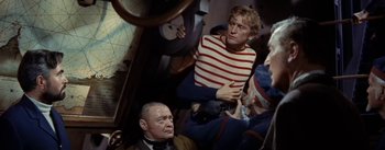 Movie still from “20,000 Leagues Under the Sea” (1954), directed by Richard Fleischer – A group of people sitting on a train; Medium shot, High angle