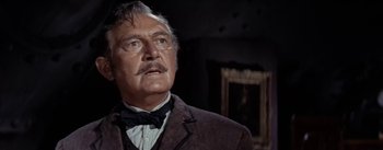 Movie still from “20,000 Leagues Under the Sea” (1954), directed by Richard Fleischer – A person wearing a suit and bow tie; Close Up shot, Low angle