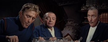 Movie still from “20,000 Leagues Under the Sea” (1954), directed by Richard Fleischer – An older man sitting in front of a table; Medium shot, Over the shoulder angle