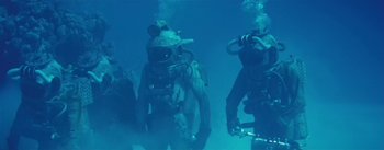 Movie still from “20,000 Leagues Under the Sea” (1954), directed by Richard Fleischer – A group of scuba divers in the water; Wide shot, Low angle