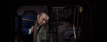 Movie still from “20,000 Leagues Under the Sea” (1954), directed by Richard Fleischer – A person in a suit and tie; Medium shot, Low angle