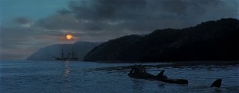 Movie still from “20,000 Leagues Under the Sea” (1954), directed by Richard Fleischer – A person in a canoe on a body of water at night; Extreme Wide shot, Low angle