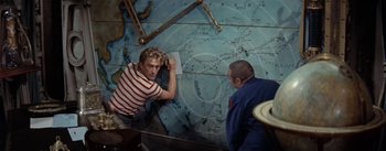 Movie still from “20,000 Leagues Under the Sea” (1954), directed by Richard Fleischer – Two men looking at a map on the wall; Medium shot, High angle