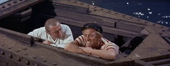 Movie still from “20,000 Leagues Under the Sea” (1954), directed by Richard Fleischer – Two men sitting on top of a wooden structure; Medium shot, High angle