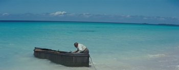 Movie still from “20,000 Leagues Under the Sea” (1954), directed by Richard Fleischer – A man sitting in a boat in the ocean; Extreme Wide shot, High angle