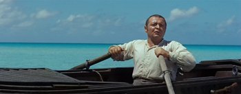 Movie still from “20,000 Leagues Under the Sea” (1954), directed by Richard Fleischer – A man rowing a boat on a body of water; Medium shot, Over the shoulder angle