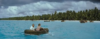 Movie still from “20,000 Leagues Under the Sea” (1954), directed by Richard Fleischer – A man and a boy are in a boat in the water; Extreme Wide shot, High angle