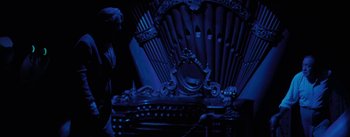 Movie still from “20,000 Leagues Under the Sea” (1954), directed by Richard Fleischer – An ornate chair in a dark room with an ornate mirror; Wide shot, Low angle