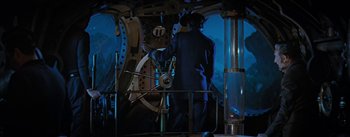Movie still from “20,000 Leagues Under the Sea” (1954), directed by Richard Fleischer – A man standing in front of a large clock; Medium shot, High angle