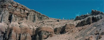 Movie still from “20,000 Leagues Under the Sea” (1954), directed by Richard Fleischer – A group of people walking up the side of a mountain; Extreme Wide shot, Low angle