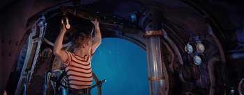 Movie still from “20,000 Leagues Under the Sea” (1954), directed by Richard Fleischer – A man standing in front of an underwater tunnel; Medium shot, High angle