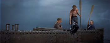 Movie still from “20,000 Leagues Under the Sea” (1954), directed by Richard Fleischer – Two men are sitting on the side of a boat; Wide shot, High angle