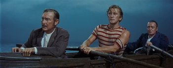 Movie still from “20,000 Leagues Under the Sea” (1954), directed by Richard Fleischer – Two men sitting in a boat on the water; Medium shot, Over the shoulder angle