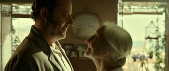 Movie still from “22 Bullets” (2010), directed by Richard Berry – An older man and a younger woman looking at each other; Close Up shot, Low angle