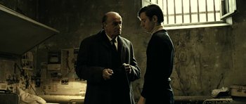 Movie still from “22 Bullets” (2010), directed by Richard Berry – A man and a man standing next to each other; Medium shot, Low angle