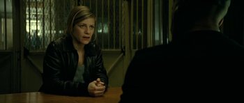 Movie still from “22 Bullets” (2010), directed by Richard Berry – A woman sitting at a table in front of a man; Medium shot, Over the shoulder angle