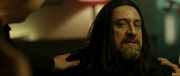 Movie still from “22 Bullets” (2010), directed by Richard Berry – A person with long black hair; Close Up shot, Over the shoulder angle