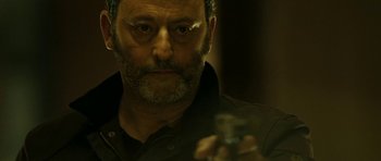 Movie still from “22 Bullets” (2010), directed by Richard Berry – A person holding a camera; Close Up shot, Low angle