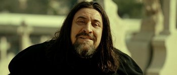 Movie still from “22 Bullets” (2010), directed by Richard Berry – A person with long hair and a beard; Close Up shot, Low angle