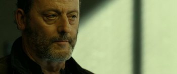 Movie still from “22 Bullets” (2010), directed by Richard Berry – A person wearing a black shirt; Close Up shot, Low angle