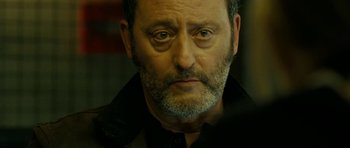 Movie still from “22 Bullets” (2010), directed by Richard Berry – An older man with a beard and mustache; Close Up shot, Over the shoulder angle